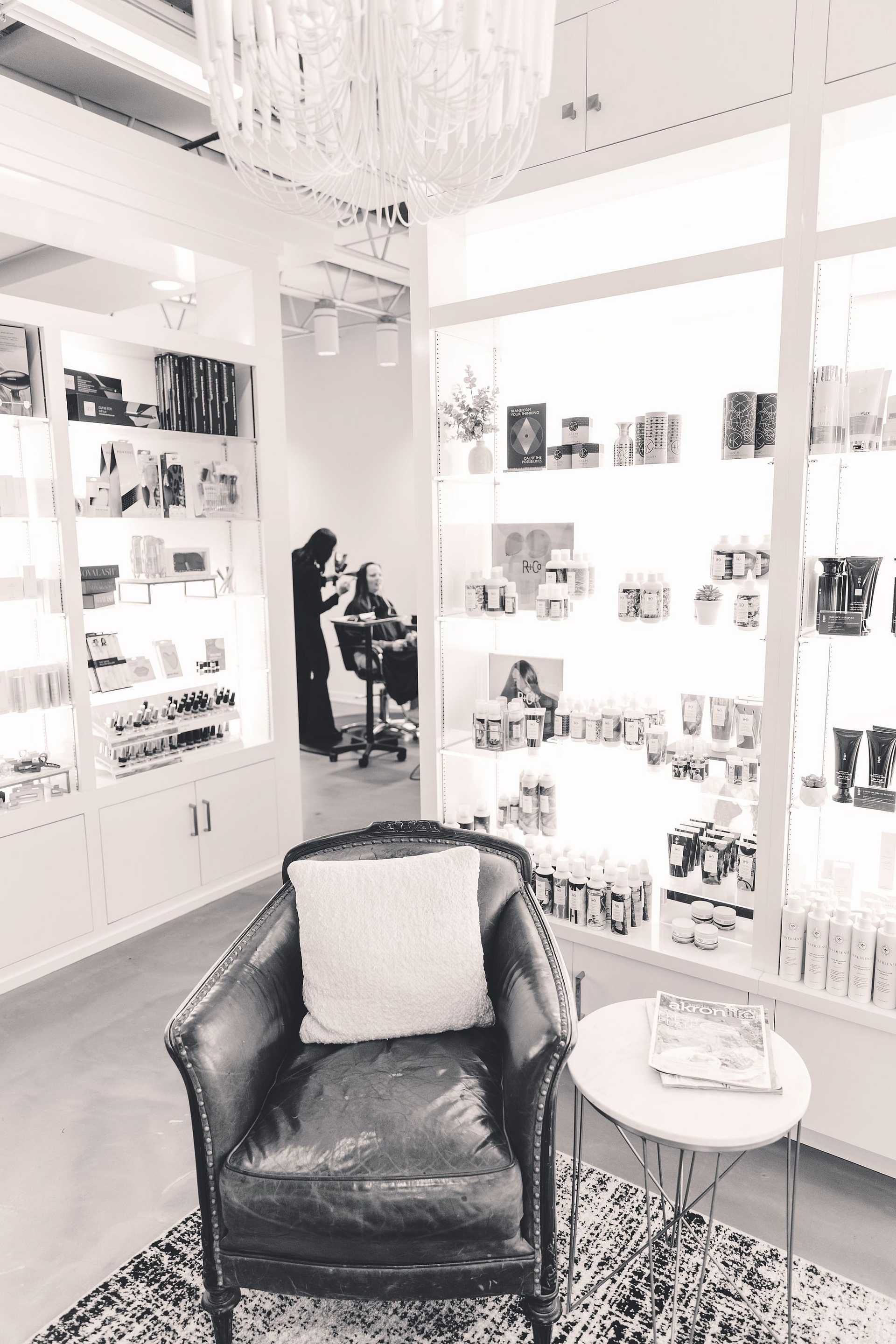 Elegant interior of a beauty salon with products and a customer.